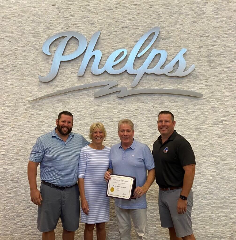 Phelps Family accepting certificate from Muscatine Chamber of Commerce
