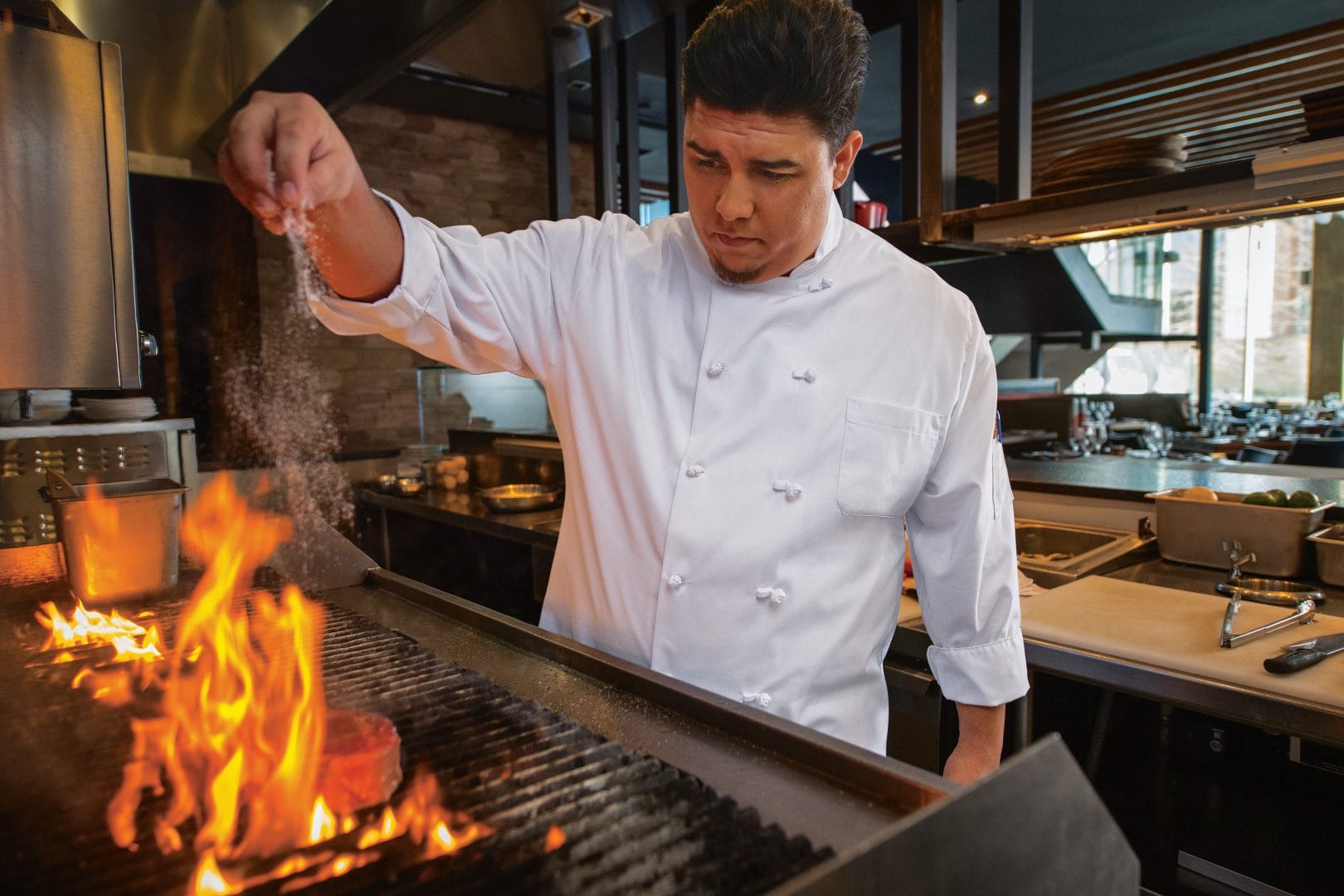 Chef cooking at the restaurant in his rented uniform.