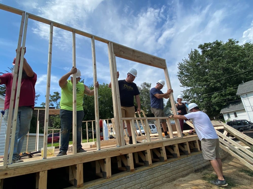 Team framing walls for a new Habitat for Humanity home.