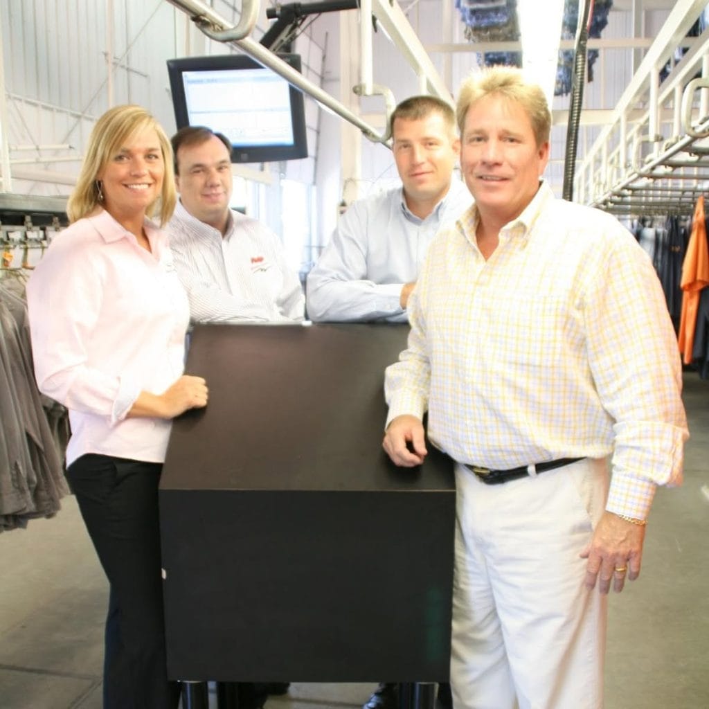 Phelps leadership business members at one of the previous laundry facilities.